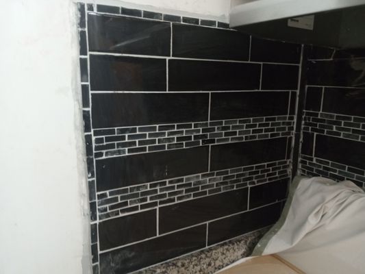 Real photo of a tile backsplash installation, closer crop